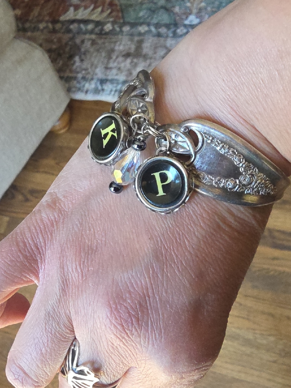 Vintage silver plated charm bracelet featuring lettered typewriter keys